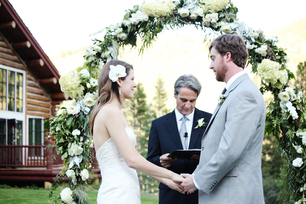 Bella Fiori Beanos Cabin Beaver Creek Colorado - floral arch in white and green flowers for a wedding ceremony