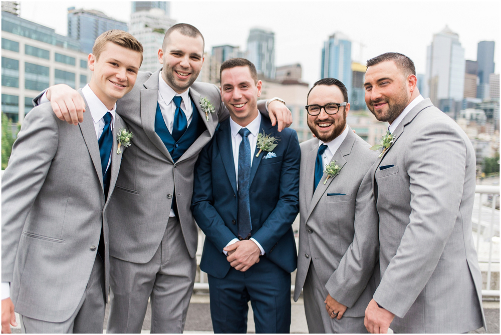 Photography: B. Jones Photography // Event Planning: Wishes! Wedding Coordination // Floral Design: Bella Fiori // Event Venue: World Trade Center Seattle DJ: DJ Headsmile // Cake Design: Honey Crumb Cake Studio - Groom and Groomsmen wearing tillandsia boutonnieres 