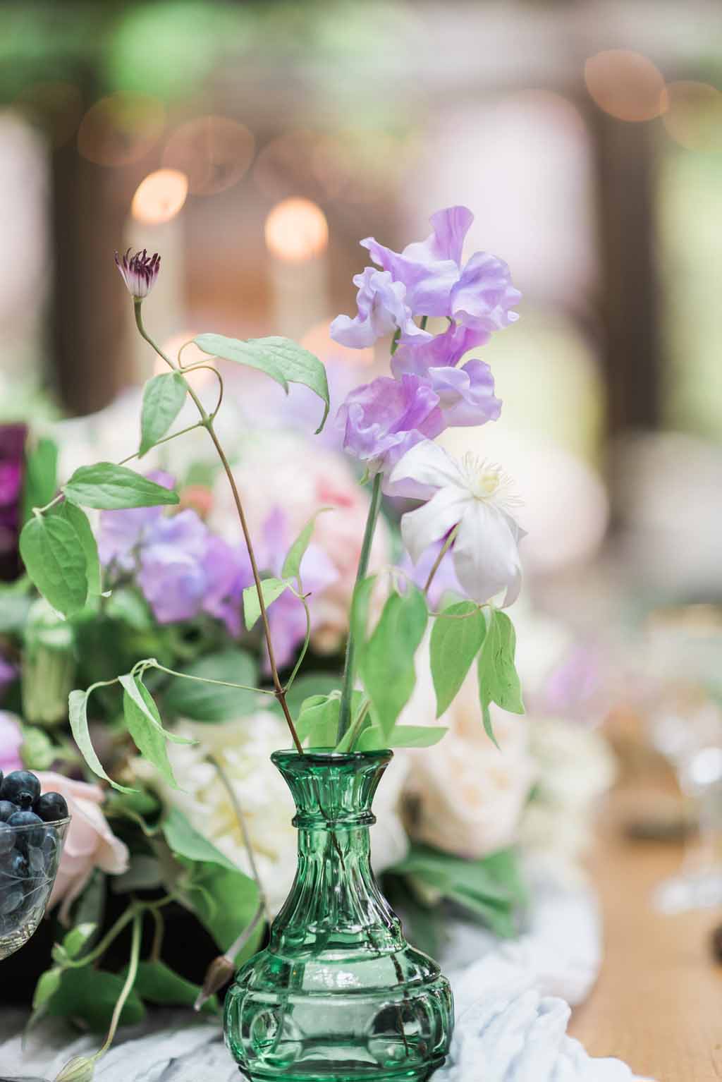 Bella Fiori Florist - Bella Luna Farms - Becca Jones Photography - Snohomish Washington - table decor designed by Alicia of Bella Fiori. Floral centerpiece created with garden roses, sweet peas, anemones, clematis in purple, lavender, and white.