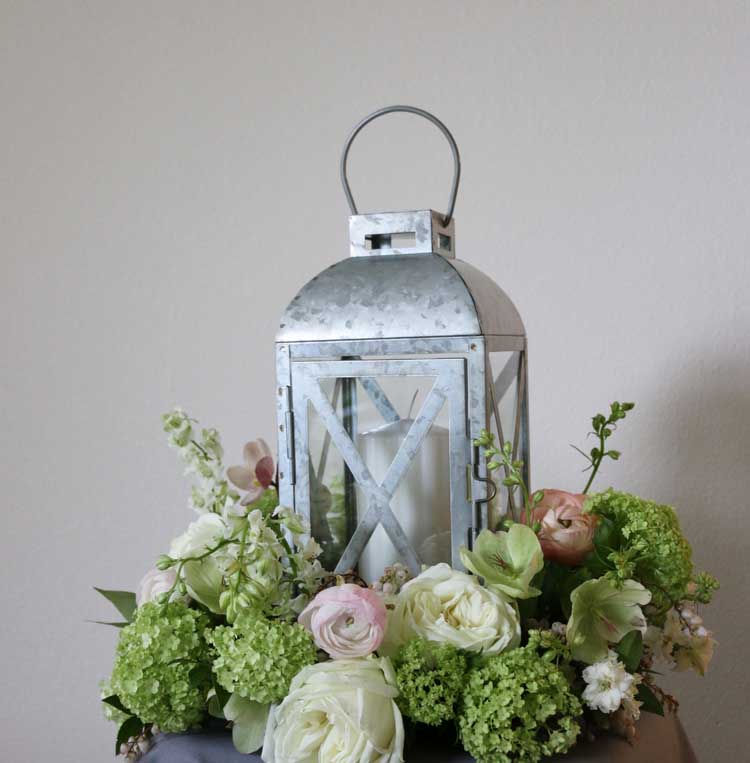 Bella Fiori Florist Mount Vernon Washington - galvanized lantern to rent for weddings. Galvanized metal lantern surrounded by a wreath of flowers. Weddings in Seattle, Woodinville, Snohomish, Skagit Valley